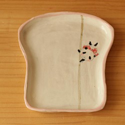 * 翻譯螞蟻產品粉桿舞熊貓麵包盤。 第1張的照片