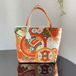 帯リメイクバッグ　アンティーク　宝尽くし文様　持ち手オレンジ　ミニトートバッグ　和装バッグ　帯バッグ　 1枚目の画像