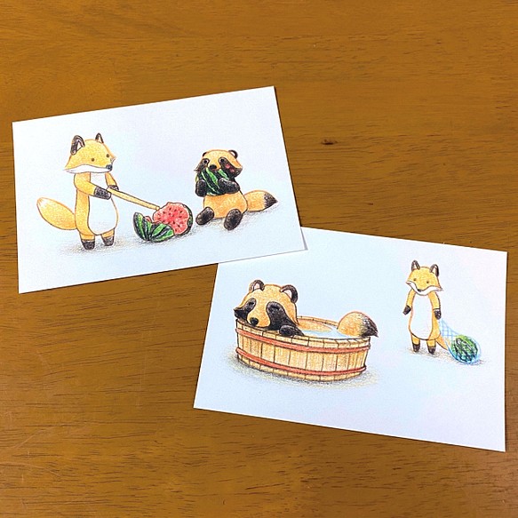 ある夏のタヌキとキツネのイラストポストカード 1枚目の画像