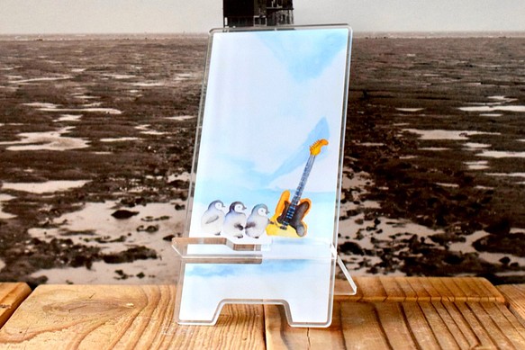 氷上でペンギンとギターが出逢うアクリルスマホスタンド 1枚目の画像