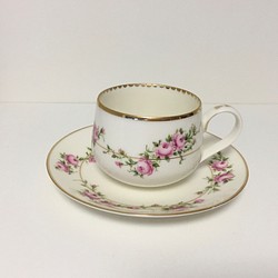 被粉紅玫瑰包圍的茶杯 第1張的照片