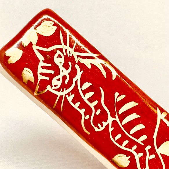 猫 箸置き 赤地に金で描く ネコと桜吹雪 1枚目の画像