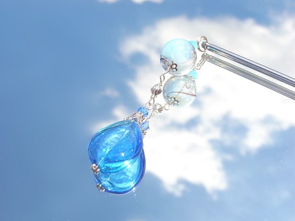 一個淡藍色的灑玻璃珠，像夏日的悠悠球一樣吹著淡藍色 第1張的照片